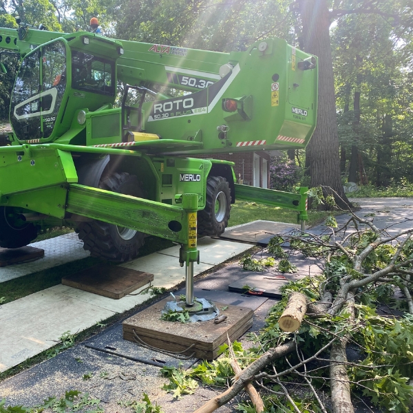 A tree crane cleaning up debris of a fallen tree after a storm in Edwardsburg, MI.