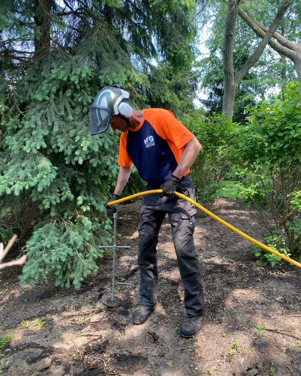 a ground crew doing fertlization of a tree in Mishawaka, IN.