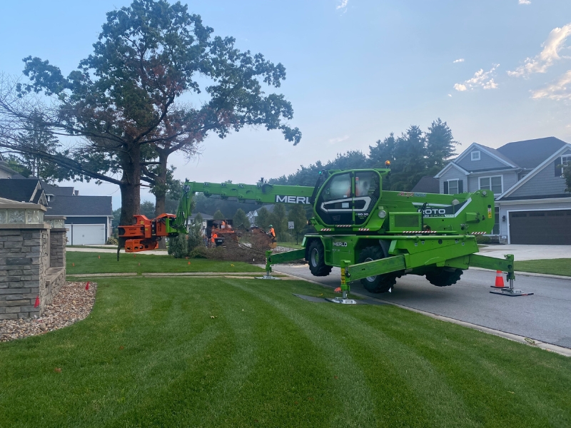 Grapple saw crane by Higher Ground Tree Care in Michigan.