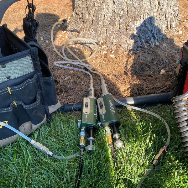 Root fertilizer solutions injected to a tree during spring in Michigan.